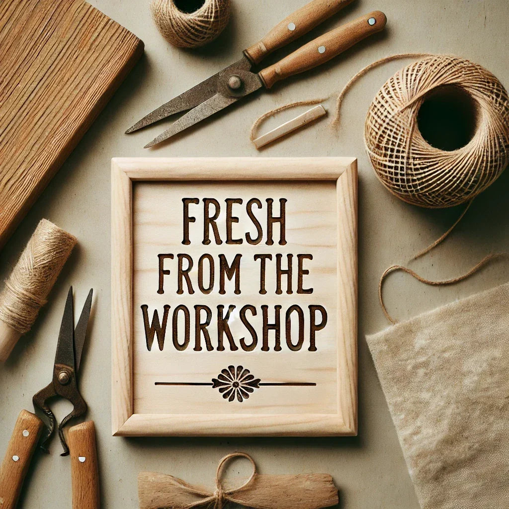 Fresh from the Workshop – flat lay of an artisan workspace with twine, tools, and a wooden sign featuring laser-engraved details. Handmade gift crafting scene